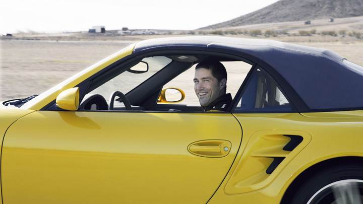 Matthew Fox Smiling In Yellow Car Photoshoot